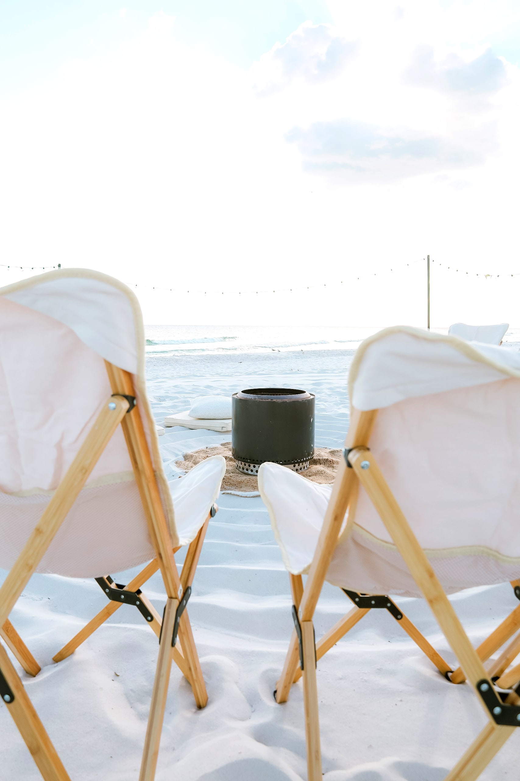 Two chairs framing the fire pit and the sea